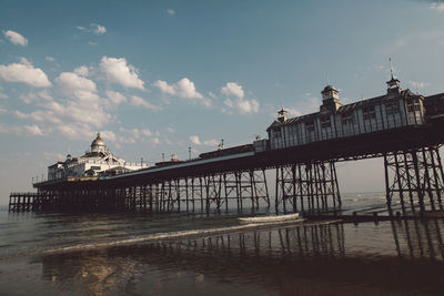 View of pier over calm sea against sky