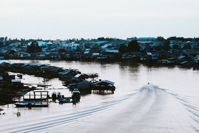 High angle view of river amidst cityscape against clear sky