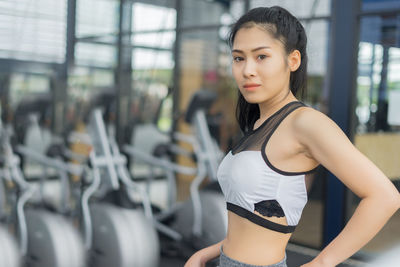 Portrait of young woman standing at gym