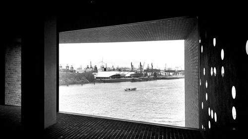 Panoramic view of city by sea against sky