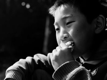 Close-up portrait of boy eating