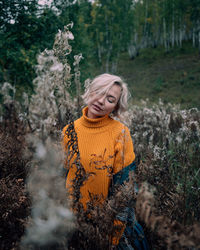 Portrait of a smiling young woman in forest