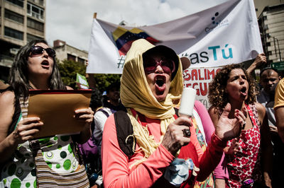 Young woman holding flag in traditional clothing