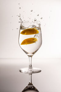 Close-up of wine glass against white background