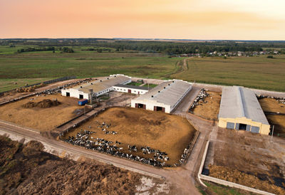 High angle view of road amidst field against sky