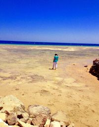 Scenic view of beach against blue sky