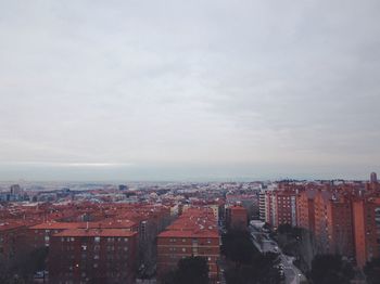 Cityscape against cloudy sky