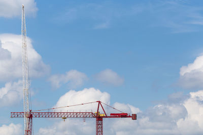 Low angle view of crane against sky