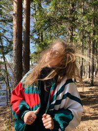 Young woman standing in forest