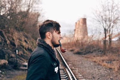 Young man smoking pipe