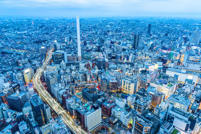 High angle view of modern buildings in city against sky