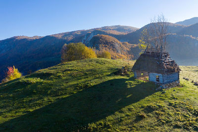 Mountain countryside homestead in the autumn. wooden barns, aerial drone view. transylvania, romania