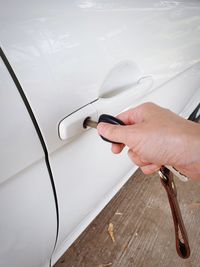 High angle view of hand holding car