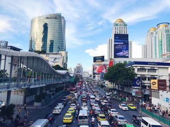 Traffic on road in city against sky