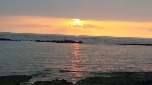 Scenic view of sea at sunset