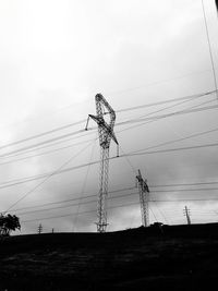 Low angle view of electricity pylon against sky