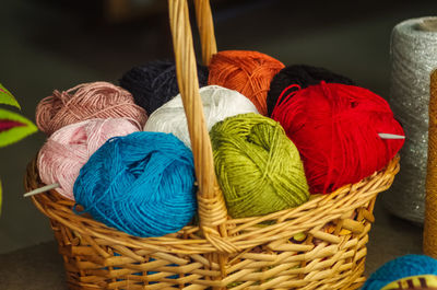 Close-up of colorful wools in wicker basket