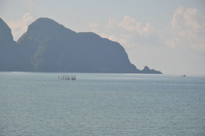 Scenic view of sea and mountains against sky