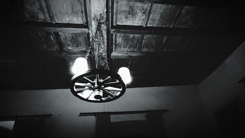 Low angle view of electric lamp hanging on ceiling