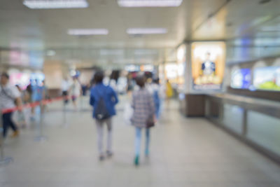 Rear view of woman walking in corridor