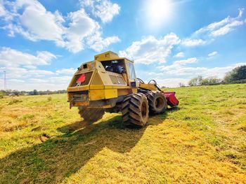 Tractor on field against sky