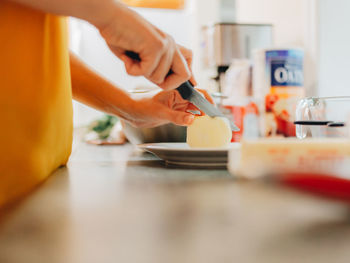 Cutting apple on kitchen counter 