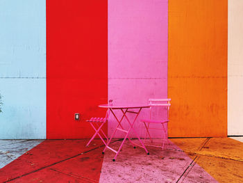 Empty chair against wall in building