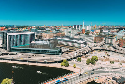 High angle view of city buildings against clear sky