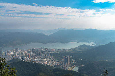 High angle view of city against cloudy sky