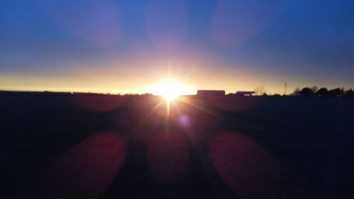 Silhouette landscape against sunset sky