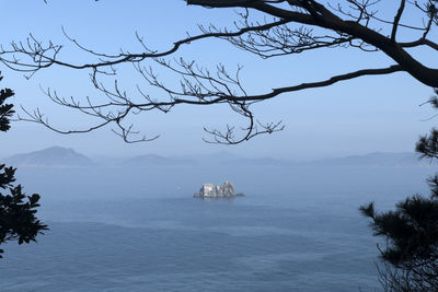 Scenic view of sea and mountains against sky