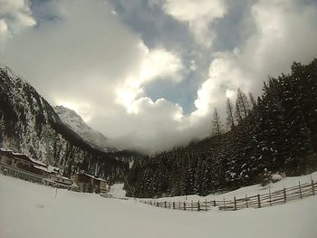 Scenic view of mountains against cloudy sky