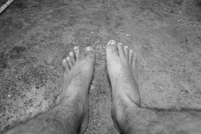 Low section of man standing on floor