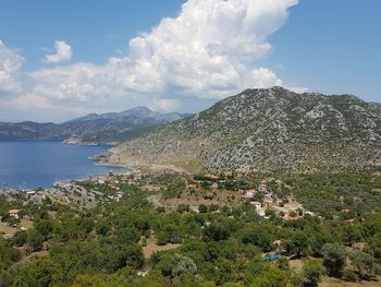 Scenic view of mountains and buildings against sky