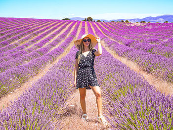 Close up of a young girl in with a hat on her head between lavender in southern provence valensole 