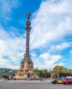 Statue of historic building against cloudy sky