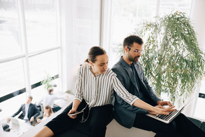 Young couple sitting on table at home