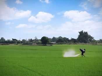 Man spraying fertilizers in farm