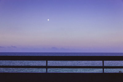 Scenic view of sea against clear sky at night