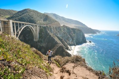 High angle view of man standing on hill by bixby creek bridge