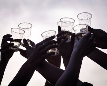 People holding glass of wine