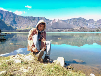 Full length of man on lake against mountains