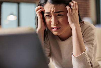 Close-up of woman using laptop