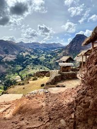 Scenic view of landscape and buildings against sky