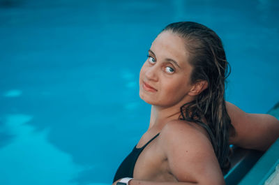 Portrait of young woman in swimming pool