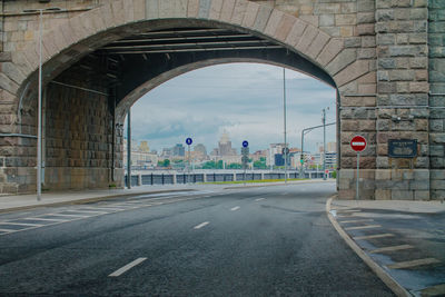 Road by bridge in city