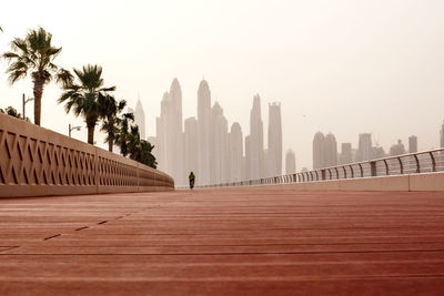 Morning walk, a man riding a bicycle on the road with a beautiful view of dubai. uae