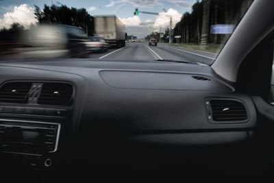 Car on road seen through windshield