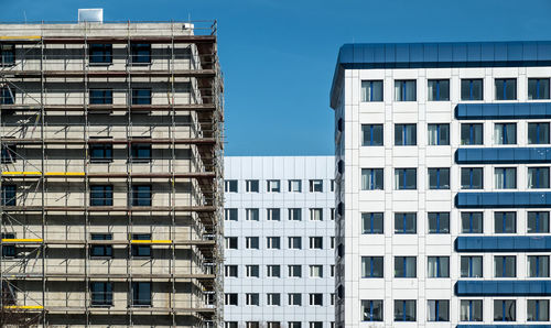 Buildings against clear blue sky