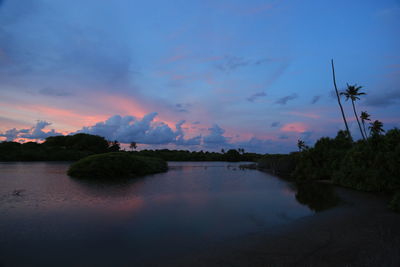 Scenic view of river against sky at sunset